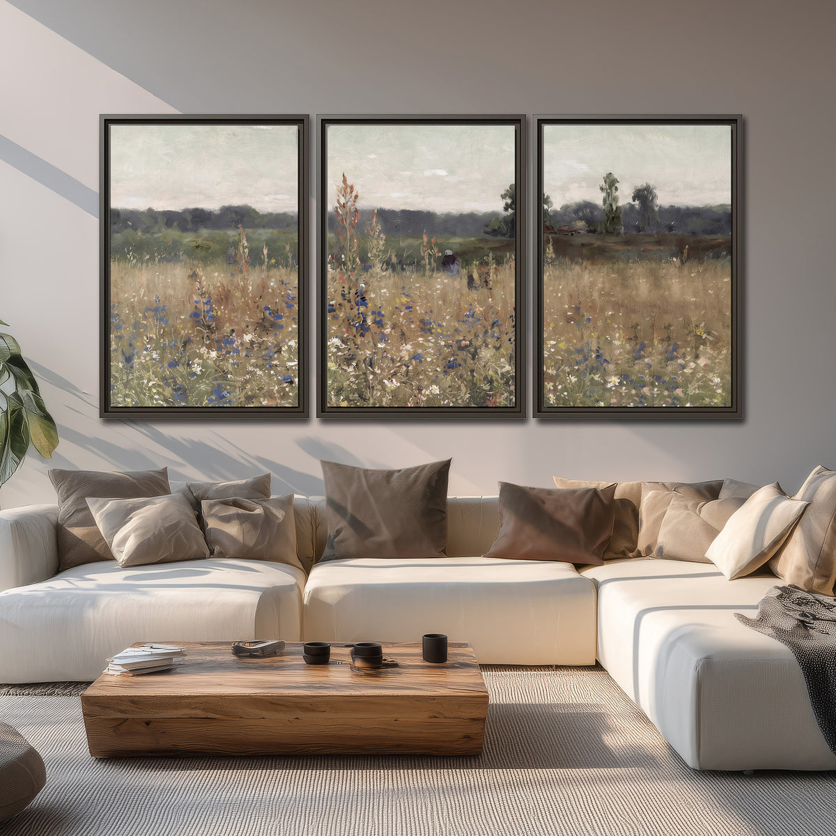 A loose painterly meadow with scattered blue and white wildflowers 3 piece framed canvas wall art displayed in a living room