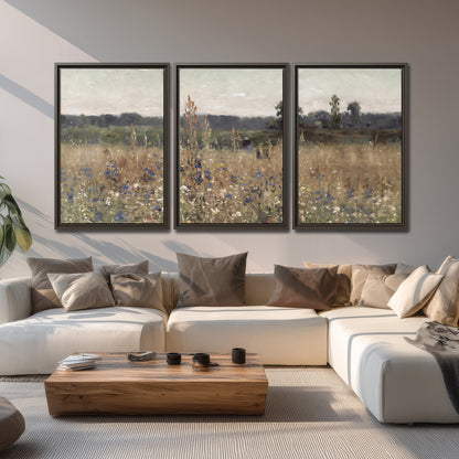 A loose painterly meadow with scattered blue and white wildflowers 3 piece framed canvas wall art displayed in a living room
