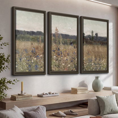 A loose painterly meadow with scattered blue and white wildflowers 3 piece framed canvas wall art displayed in a console