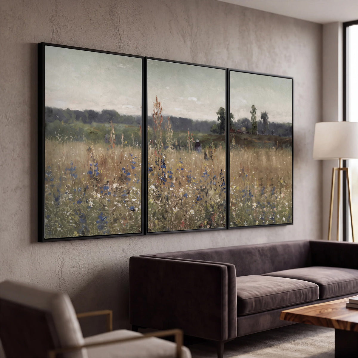 A loose painterly meadow with scattered blue and white wildflowers 3 piece framed canvas wall art displayed in a modern living room