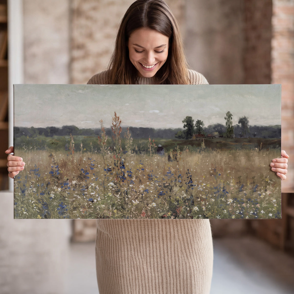 A loose painterly meadow with scattered blue and white wildflowers single canvas wall art held in hands