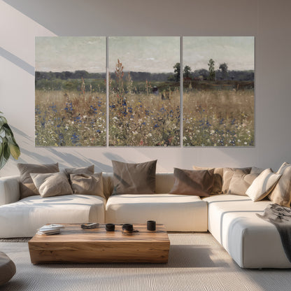 A loose painterly meadow with scattered blue and white wildflowers set of 3 poster prints displayed in a living room