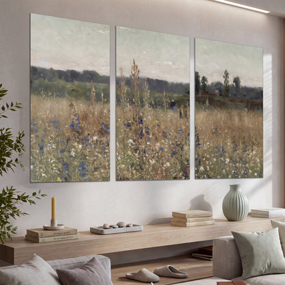 A loose painterly meadow with scattered blue and white wildflowers set of 3 poster prints displayed in a console