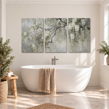 Trailing white blossoms and delicate green branches on pale gray 3 piece canvas wall art styled in an interior