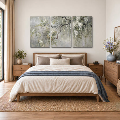 Trailing white blossoms and delicate green branches on pale gray 3 piece canvas wall art styled in an interior