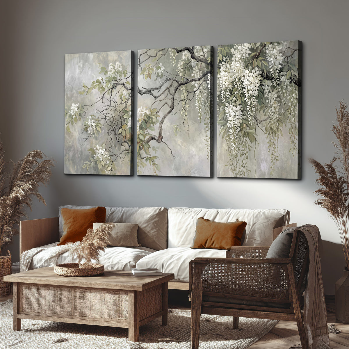 Trailing white blossoms and delicate green branches on pale gray 3 piece canvas wall art displayed in a rustic living room