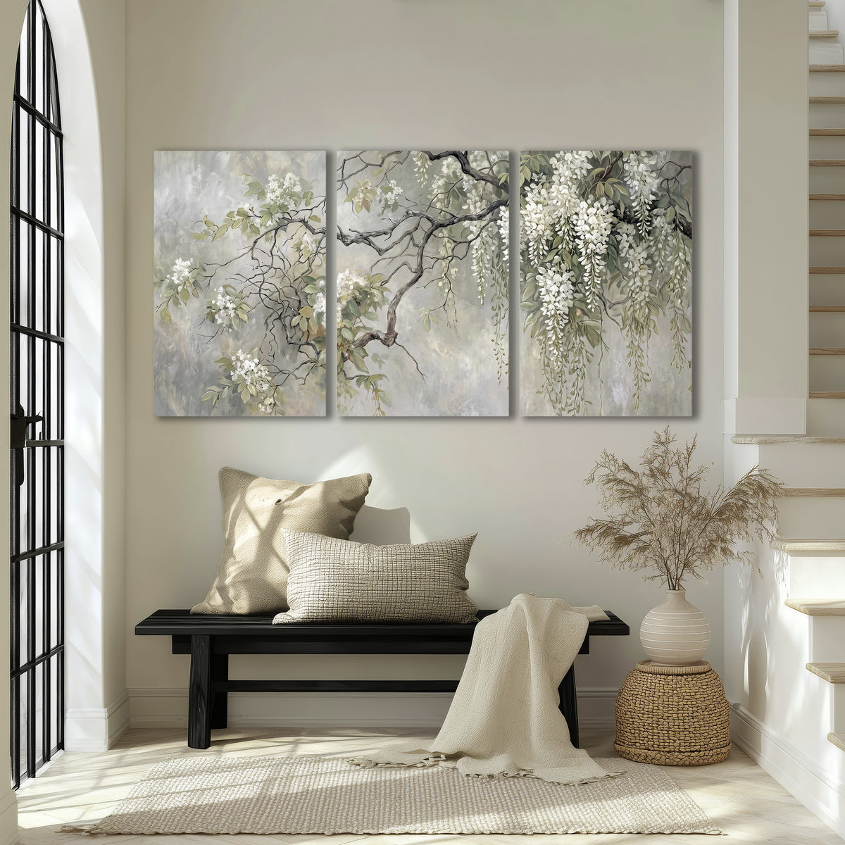 Trailing white blossoms and delicate green branches on pale gray 3 piece canvas wall art displayed in a entryway