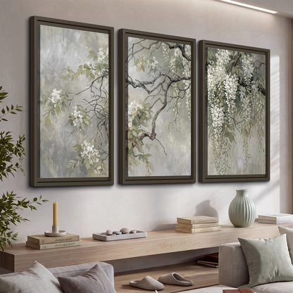 Trailing white blossoms and delicate green branches on pale gray 3 piece framed canvas wall art displayed in a console