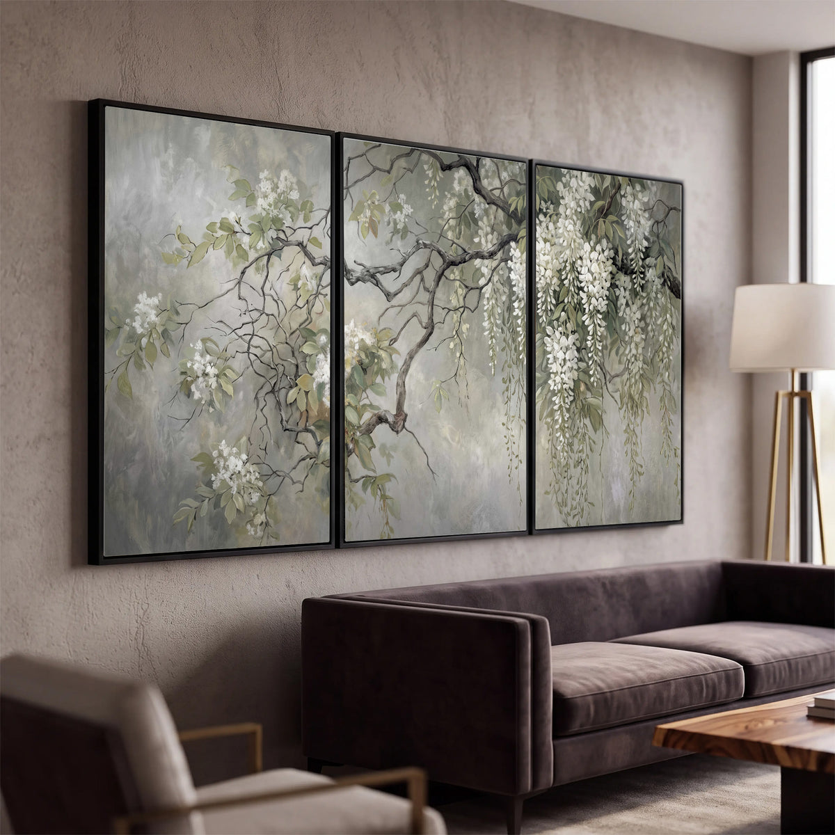 Trailing white blossoms and delicate green branches on pale gray 3 piece framed canvas wall art displayed in a modern living room