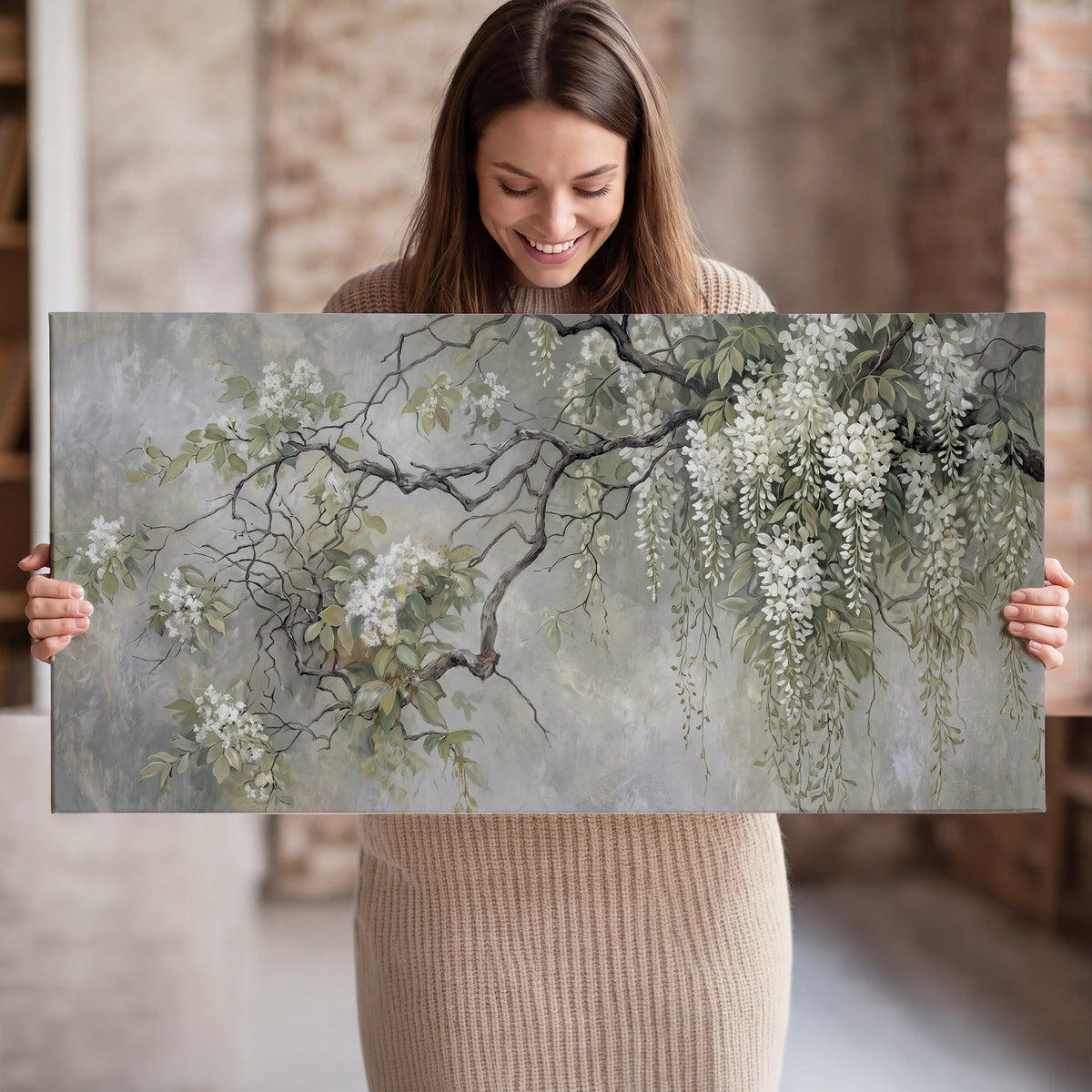 Trailing white blossoms and delicate green branches on pale gray single canvas wall art held in hands