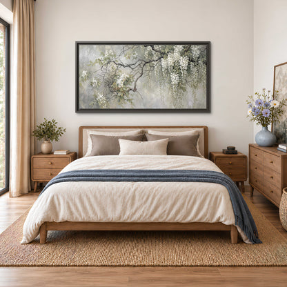 Trailing white blossoms and delicate green branches on pale gray single framed canvas wall art styled in an interior