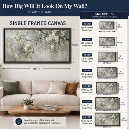 Trailing white blossoms and delicate green branches on pale gray single framed canvas wall art size guide above a sofa; room view is illustrative