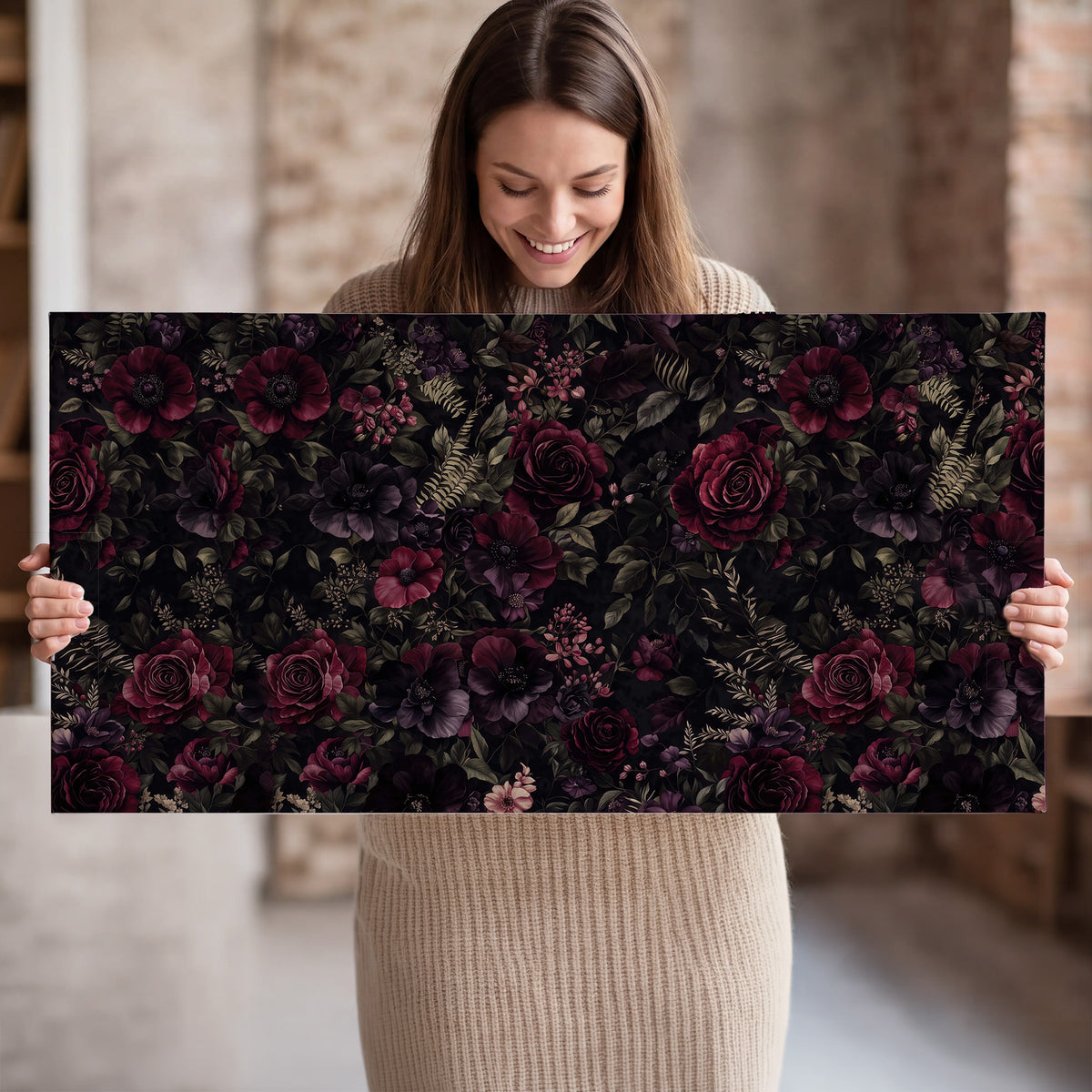 Deep burgundy roses and small pale flowers on a dark background single canvas wall art held in hands