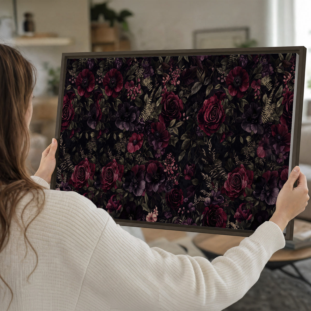 Deep burgundy roses and small pale flowers on a dark background single framed canvas wall art held in hands