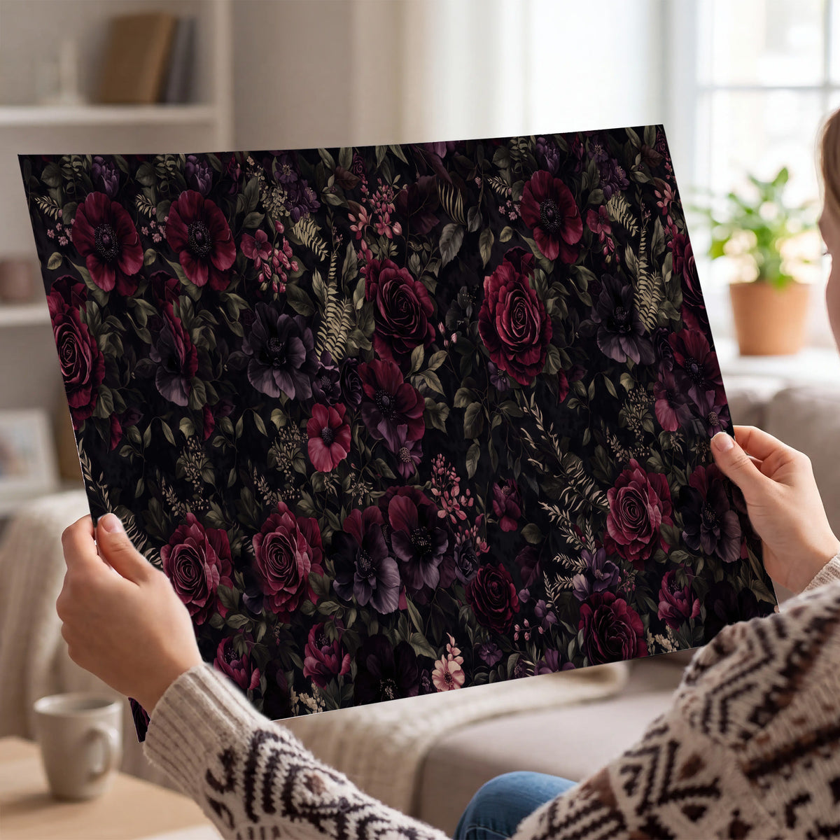 Deep burgundy roses and small pale flowers on a dark background single poster print held in hands