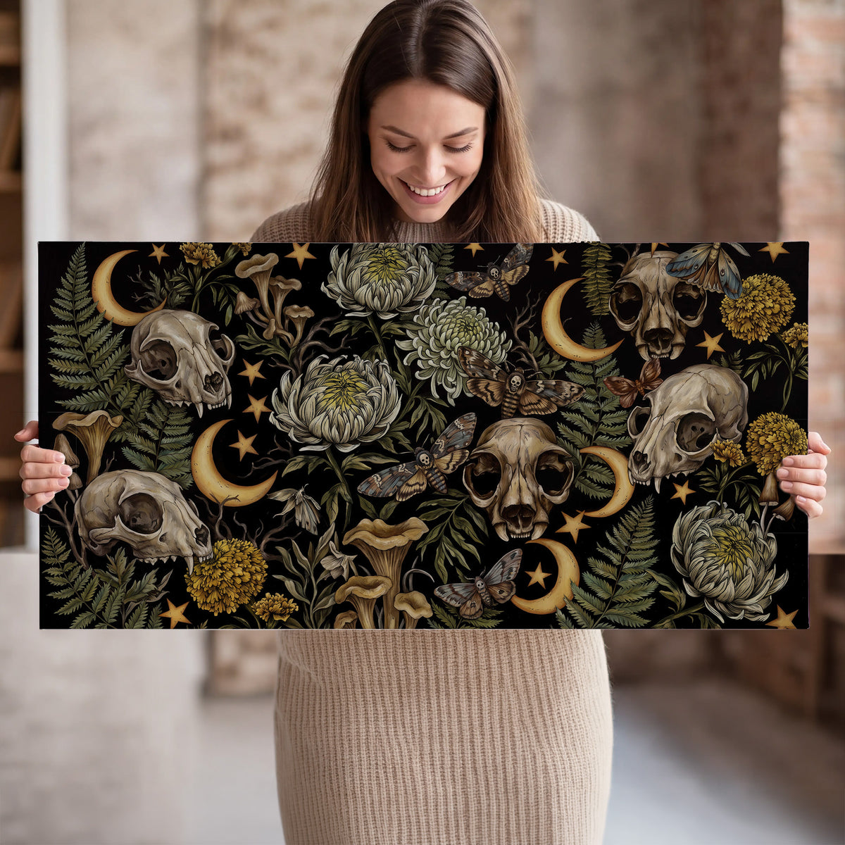 Decorative animal skulls, moons, stars, mushrooms and botanical leaves single canvas wall art held in hands