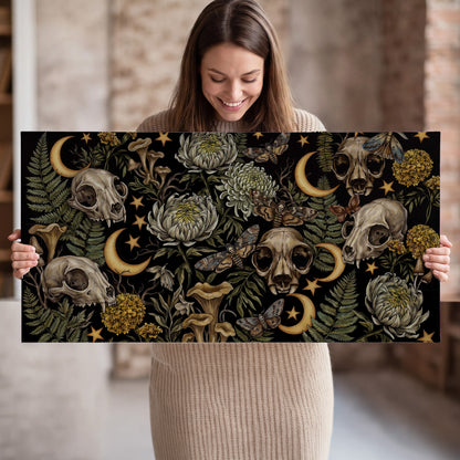 Decorative animal skulls, moons, stars, mushrooms and botanical leaves single canvas wall art held in hands