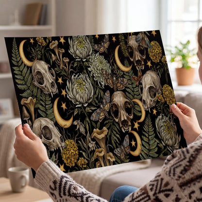 Decorative animal skulls, moons, stars, mushrooms and botanical leaves single poster print held in hands