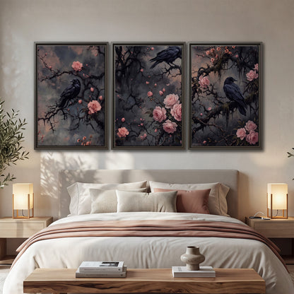 Black ravens perched among pink roses and dark branches 3 piece framed canvas wall art displayed in a bedroom