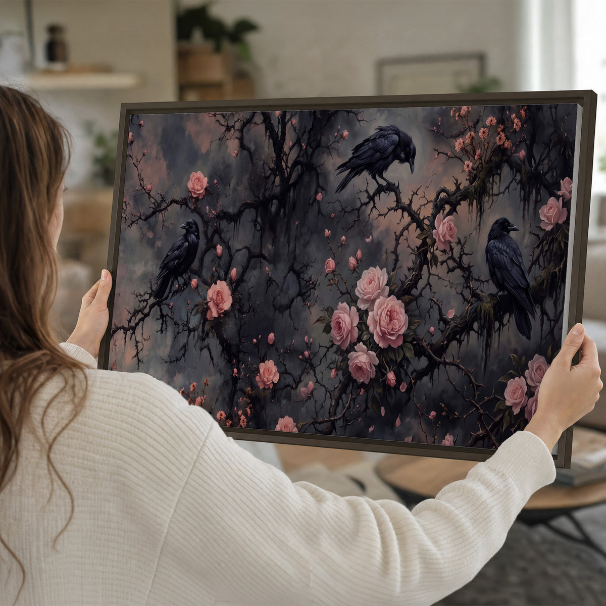 Black ravens perched among pink roses and dark branches single framed canvas wall art held in hands