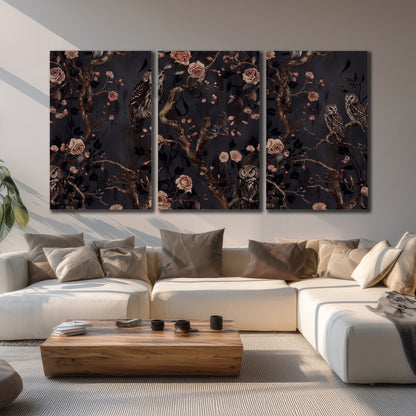 Owls among curling branches and dusty pink flowers on dark gray 3 piece canvas wall art displayed in a living room