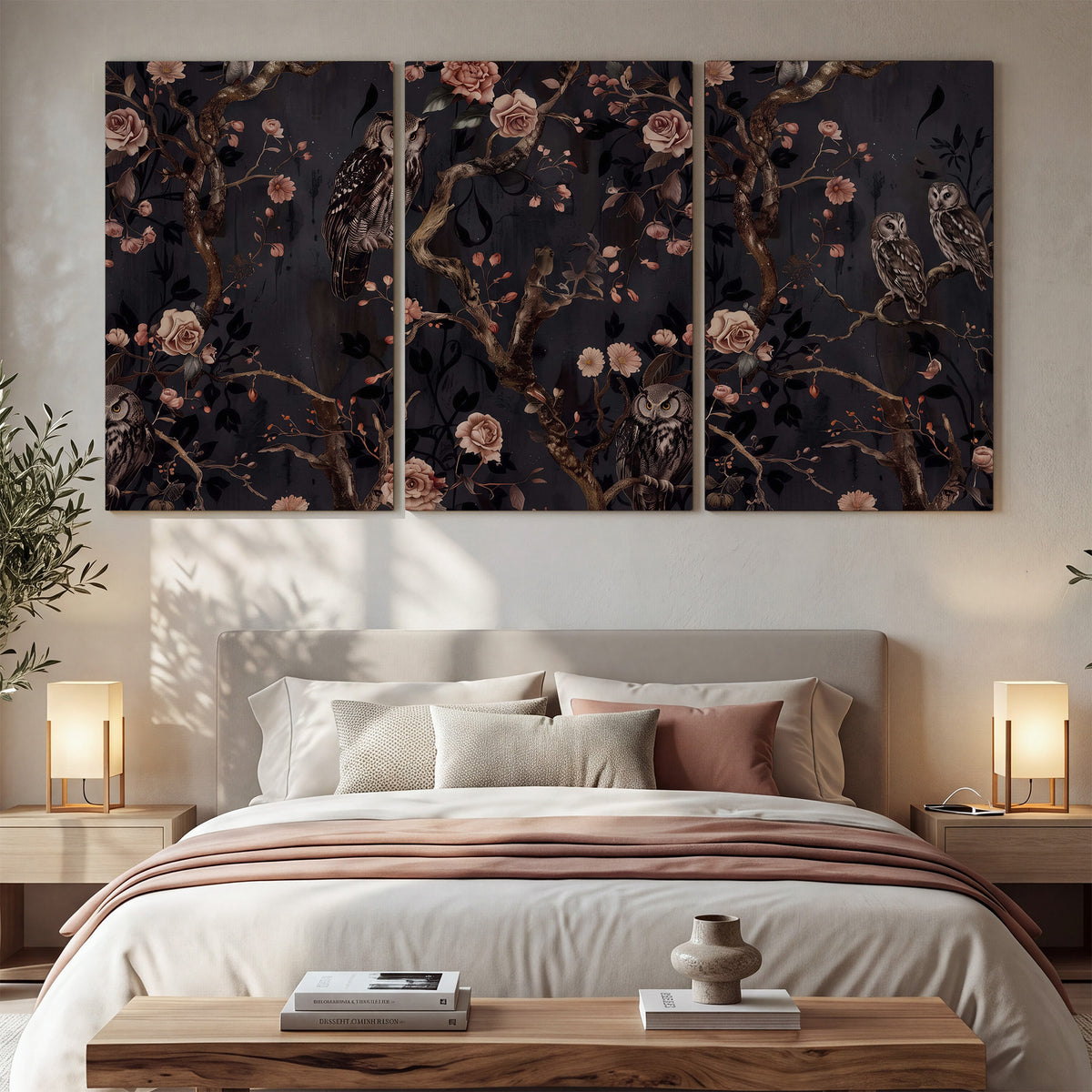 Owls among curling branches and dusty pink flowers on dark gray 3 piece canvas wall art displayed in a bedroom