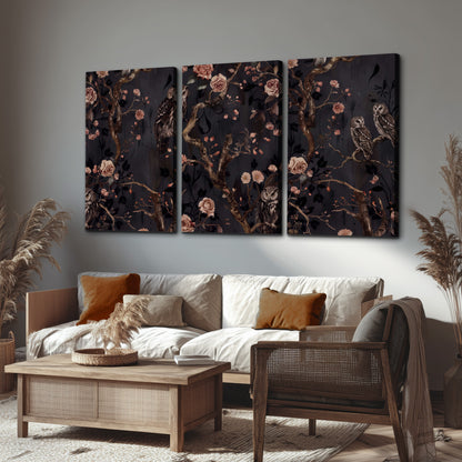 Owls among curling branches and dusty pink flowers on dark gray 3 piece canvas wall art displayed in a rustic living room