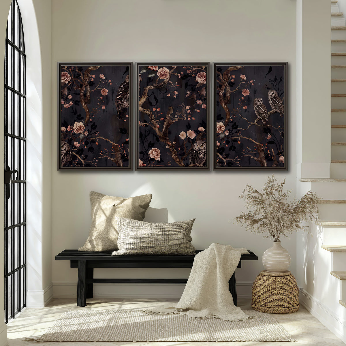 Owls among curling branches and dusty pink flowers on dark gray 3 piece framed canvas wall art displayed in a entryway