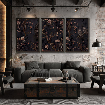 Owls among curling branches and dusty pink flowers on dark gray 3 piece framed canvas wall art displayed in a industrial room