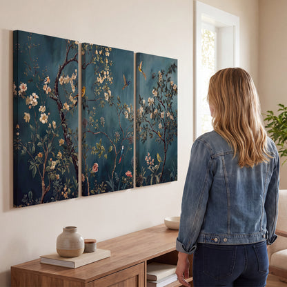 Colorful birds and pale blossoms on branches against teal blue 3 piece canvas wall art three panel arrangement on a wall