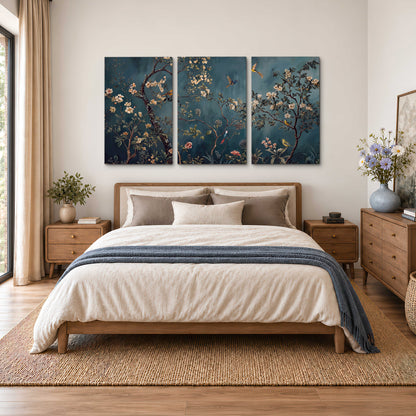 Colorful birds and pale blossoms on branches against teal blue 3 piece canvas wall art styled in an interior