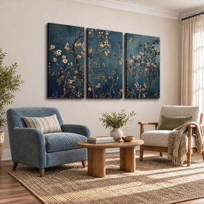 Colorful birds and pale blossoms on branches against teal blue 3 piece canvas wall art styled in an interior