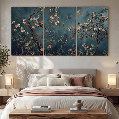 Colorful birds and pale blossoms on branches against teal blue 3 piece canvas wall art displayed in a bedroom