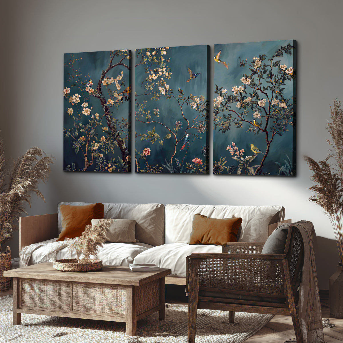 Colorful birds and pale blossoms on branches against teal blue 3 piece canvas wall art displayed in a rustic living room