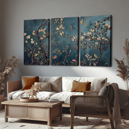 Colorful birds and pale blossoms on branches against teal blue 3 piece canvas wall art displayed in a rustic living room
