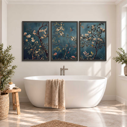 Colorful birds and pale blossoms on branches against teal blue 3 piece framed canvas wall art styled in an interior