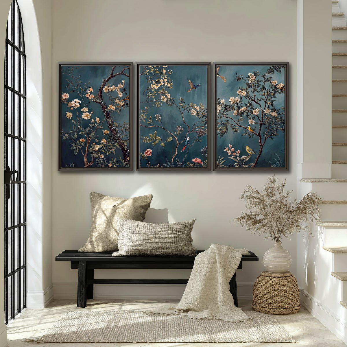 Colorful birds and pale blossoms on branches against teal blue 3 piece framed canvas wall art displayed in a entryway