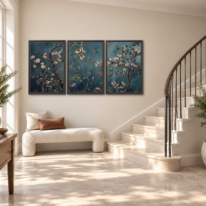 Colorful birds and pale blossoms on branches against teal blue 3 piece framed canvas wall art styled in an interior