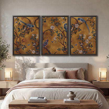 Colorful perched birds and pale blossoms on an ochre background 3 piece framed canvas wall art displayed in a bedroom