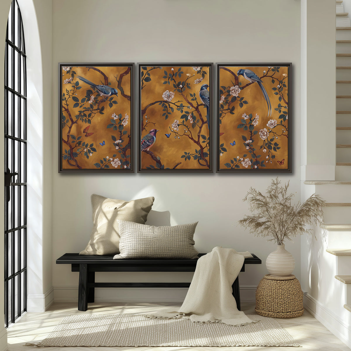 Colorful perched birds and pale blossoms on an ochre background 3 piece framed canvas wall art displayed in a entryway