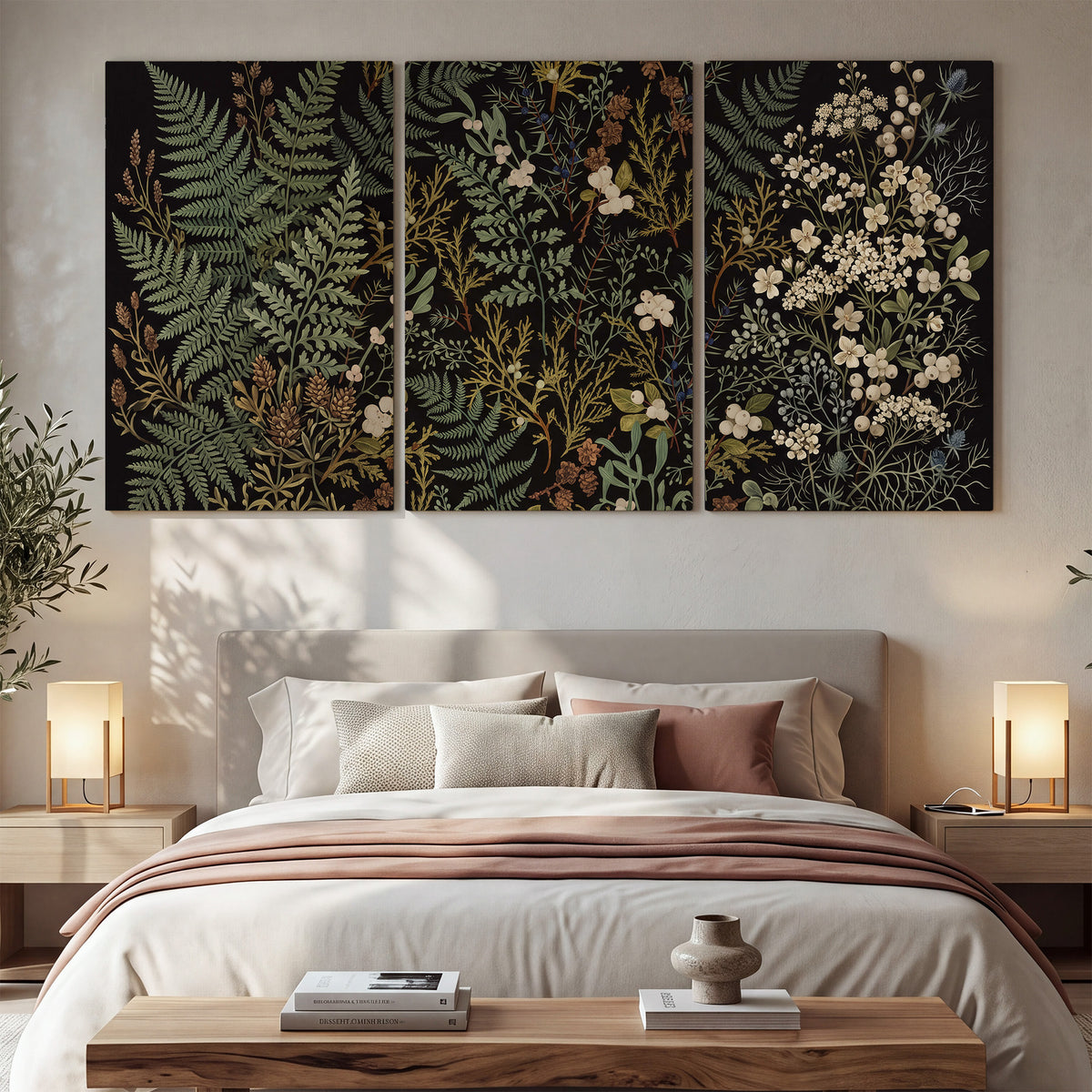Layered green ferns and delicate cream flowers on a black background 3 piece canvas wall art displayed in a bedroom