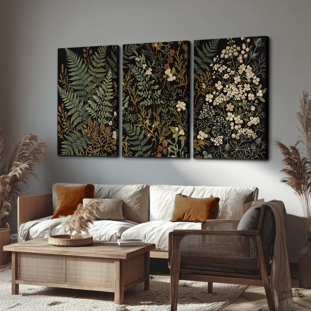 Layered green ferns and delicate cream flowers on a black background 3 piece canvas wall art displayed in a rustic living room