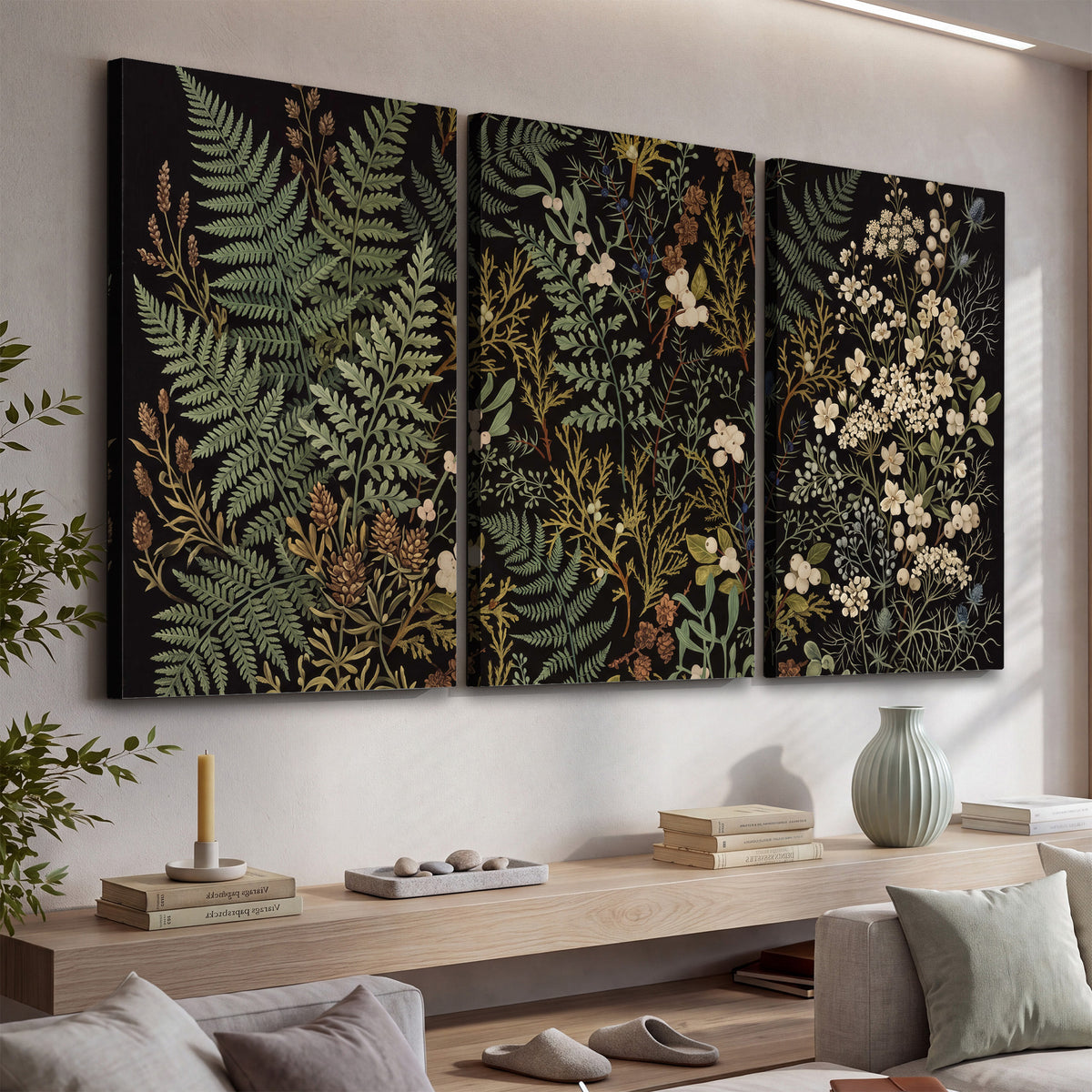 Layered green ferns and delicate cream flowers on a black background 3 piece canvas wall art displayed in a console