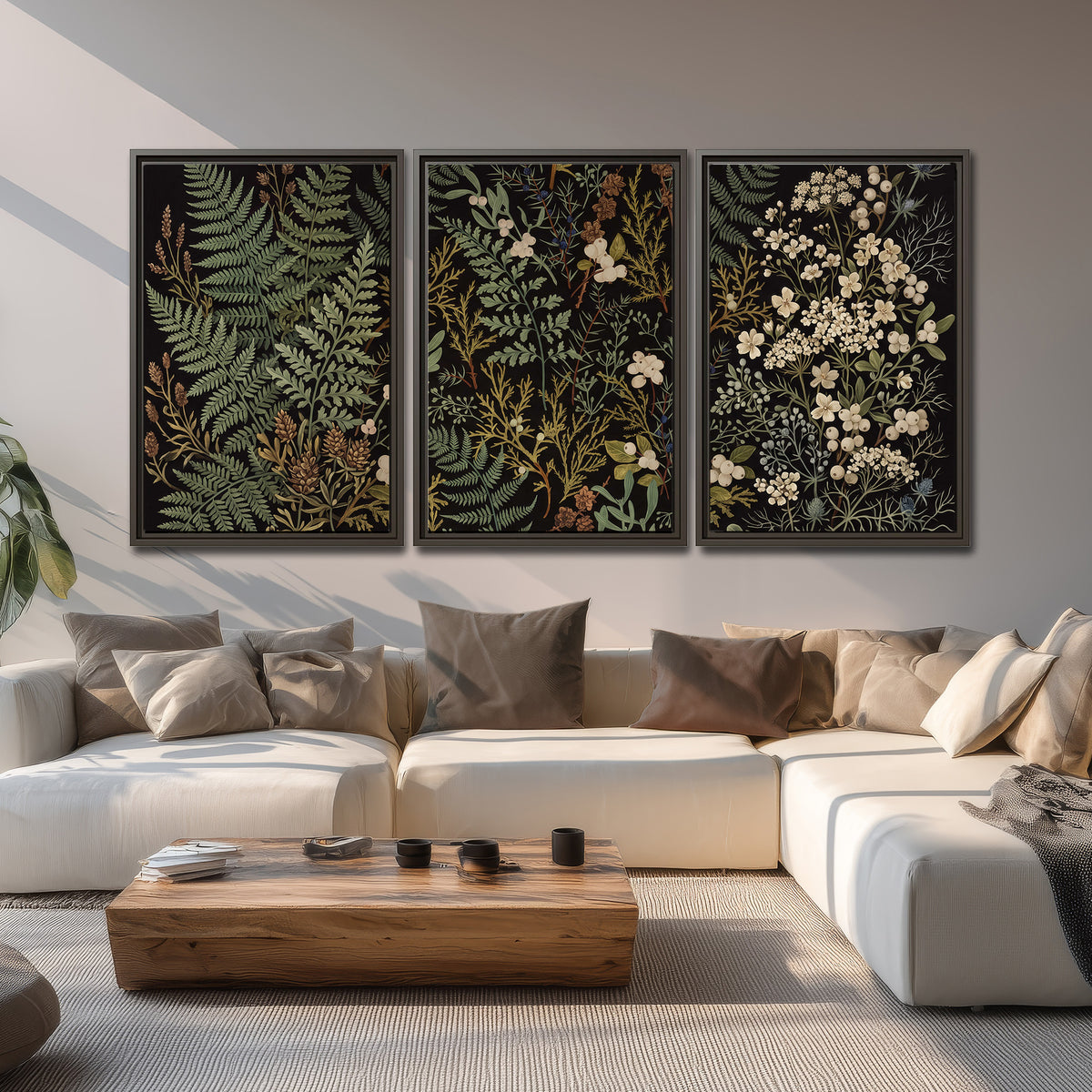 Layered green ferns and delicate cream flowers on a black background 3 piece framed canvas wall art displayed in a living room