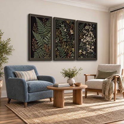 Layered green ferns and delicate cream flowers on a black background 3 piece framed canvas wall art styled in an interior
