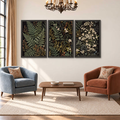 Layered green ferns and delicate cream flowers on a black background 3 piece framed canvas wall art styled in an interior