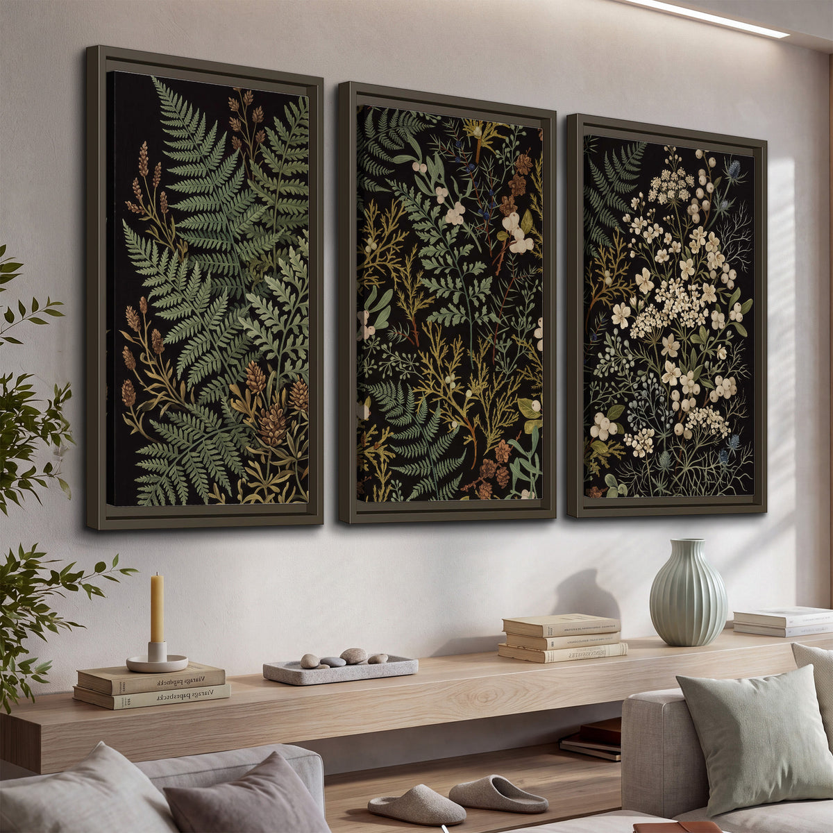 Layered green ferns and delicate cream flowers on a black background 3 piece framed canvas wall art displayed in a console