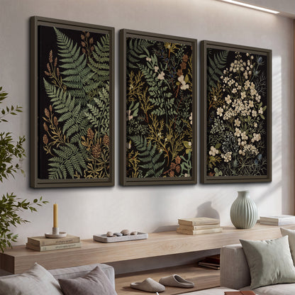 Layered green ferns and delicate cream flowers on a black background 3 piece framed canvas wall art displayed in a console