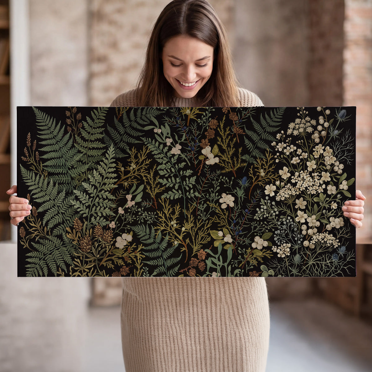 Layered green ferns and delicate cream flowers on a black background single canvas wall art held in hands
