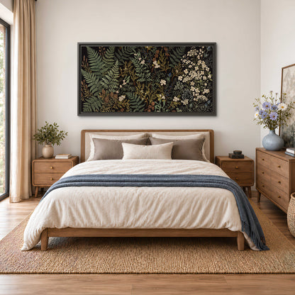 Layered green ferns and delicate cream flowers on a black background single framed canvas wall art styled in an interior